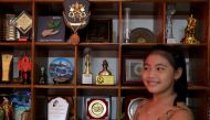 Licypriya Kangujam, 8, India's young climate activist, poses in front of her trophies at her house in Noida, on the outskirts of New Delhi, India, September 21, 2020. Picture taken September 21, 2020. Reuters/Anushree Fadnavis