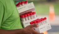 FILE PHOTO: A healthcare worker carries specimen collection tubes at a coronavirus disease (COVID-19) drive-in testing location in Houston, Texas, U.S., August 18, 2020. REUTERS/Adrees Latif/File Photo
