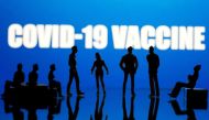 Small toy figures are seen in front of a Covid-19 Vaccine logo in this illustration taken, September 9, 2020. REUTERS/Dado Ruvic/Illustration/File Photo
