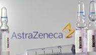 FILE PHOTO: A test-tube labelled vaccine is seen in front of AstraZeneca logo in this illustration taken, September 9, 2020. REUTERS/Dado Ruvic/Illustration/File Photo
