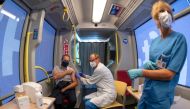 A man receives a flu vaccine inside the mobile vaccination station 