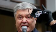 FILE PHOTO: Ukraine's former President Petro Poroshenko, who is suspected of abuse of office, holds a protective face mask while addressing journalists and his supporters before entering a court building in Kyiv, Ukraine June 18, 2020. REUTERS/Gleb Garani
