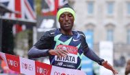 Ethiopia's Shura Kitata breaks the tape as he wins the elite men's race of the 2020 London Marathon in central London on October 4, 2020. This year's London marathon, an elite-athlete only event, takes place in a 