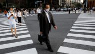FILE PHOTO: People wearing protective masks make their way amid the coronavirus disease (COVID-19) pandemic at a business district in Tokyo, Japan August 4, 2020. REUTERS/Kim Kyung-Hoon/File Photo 