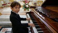 Guillaume Benoliel, a six-year-old child, plays the piano during a practice session in a church in Brunoy, France, October 5, 2020. Picture taken October 5, 2020. REUTERS/Noemie Olive
