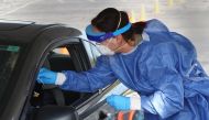 Members of the Wisconsin National Guard test residents for the coronavirus COVID-19 at a temporary test facility set up in the parking lot of the UMOS corporate headquarters on October 09, 2020 in Milwaukee, Wisconsin. Wisconsin currently has one of the h