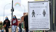 Pedestrians and shoppers, some wearing face masks as a precaution against the transmission of the novel coronavirus, walk in the high street in west London on October 11, 2020. / AFP / JUSTIN TALLIS