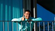 TOPSHOT - This handout picture released on October 13, 2020 by the Portuguese Football Federation shows Portugal´s forward Cristiano Ronaldo giving the thumb up as he watches his teammates training session from a balcony at Portugal´s training camp in Oei
