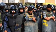 Members of the Iraqi security forces stand guard as demonstrators, supporters of the Hashed al Shaabi, ransack the Kurdish Democratic Party's headquarters in the capital Baghdad on October 17, 2020. AFP / AHMAD AL-RUBAYE