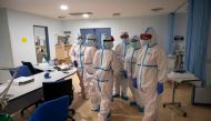 Healthcare workers chat at the Intensive Care Unit (ICU) of the Severo Ochoa University Hospital in Leganes on October 16, 2020. At Severo Ochoa hospital in a Madrid suburb badly-hit during the pandemic's first wave, the intensive care unit is once again 