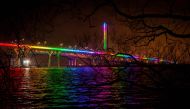 TOPSHOT - Samuel de Champlain Bridge is illuminated in the colors of the rainbow as a symbol of support during the novel coronavirus pandemic in Montreal, Quebec, Canada, on April 19, 2020. / AFP / Sebastien St-Jean
