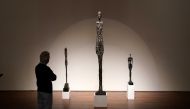 A person looks at Alberto Giacometti's 