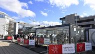 People queue to be screened for Covid-19 at a testing station set up at Brussels Airport, in Zaventem, on October 26, 2020. Belgium OUT / AFP / Belga / ERIC LALMAND