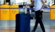 FILE PHOTO: A passenger walks past a Lufthansa ticket counter at Frankfurt Airport in Frankfurt, Germany, September 21, 2020. REUTERS/Ralph Orlowski