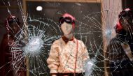A damaged window of a store is seen as people protest against the new restrictions introduced by the government to curb the coronavirus disease (COVID-19) infections, in Turin, Italy, October 26, 2020. REUTERS/Massimo Pinca TPX IMAGES OF THE DAY
