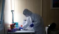 A healthcare worker works at a COVID-19 testing site as the spread of the coronavirus disease (COVID-19) continues in Budapest, Hungary, October 27, 2020. REUTERS/Bernadett Szabo/File Photo