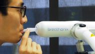 A staff member demonstrates the usage of Breathonix breathalyzer test kit developed by Breathonix, a start-up by the National University of Singapore, able to detect the coronavirus disease (COVID-19) within a minute according to the company, at their lab