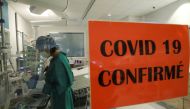 A health worker standing in an intensive care unit treats a patient suffering from the coronavirus disease (COVID-19), at Montlegia CHC clinic in Liege, Belgium October 29, 2020. REUTERS/Yves Herman