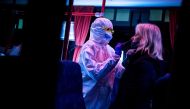 A medic tests a woman for the novel coronavirus COVID-19 during nationwide testing in Bratislava, Slovakia on October 31, 2020. / AFP / VLADIMIR SIMICEK