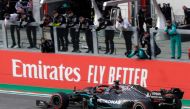 Mercedes' British driver Lewis Hamilton celebrates with his team after crossing the finish line to win the Formula One Emilia Romagna Grand Prix at the Autodromo Internazionale Enzo e Dino Ferrari race track in Imola, Italy, on November 1, 2020. / AFP / L
