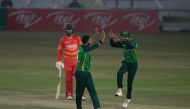 Pakistan's captain Babar Azam (R) celebrates with teammate Imad Wasim (C) the dismissal of Zimbabwe's Craig Ervine during the first one-day international (ODI) cricket match between Pakistan and Zimbabwe at the Rawalpindi Cricket Stadium in Rawalpindi on 