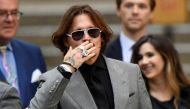 FILE PHOTO: Actor Johnny Depp gestures as he leaves the High Court in London, Britain July 28, 2020. REUTERS/Toby Melville/File Photo