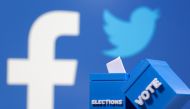 3D printed ballot boxes are seen in front of displayed Facebook and Twitter logos in this illustration taken November 4, 2020. REUTERS/Dado Ruvic/Illustration
