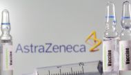 A test tube labelled with the Vaccine is seen in front of AstraZeneca logo in this illustration taken, September 9, 2020. REUTERS/Dado Ruvic/Illustration/File Photo