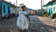 A child plays in a street in the city of Gondar, on November 09, 2020. / AFP / EDUARDO SOTERAS