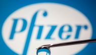 Pfizer's logo is reflected in a drop on a syringe needle in this illustration taken November 9, 2020. REUTERS/Dado Ruvic/Illustration/File Photo