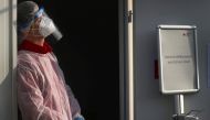 A member of Germany's Red Cross medical staff waits for people at a newly installed drive- and walk-in corona test centre as the spread of the coronavirus disease (COVID-19) continues in Frankfurt, Germany, November 13, 2020. REUTERS/Kai Pfaffenbach/File 