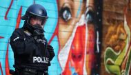A police officer prepares before protest against the government's restrictions, amid the coronavirus disease (COVID-19) outbreak, in Frankfurt, Germany, November 14, 2020. REUTERS/Kai Pfaffenbach
