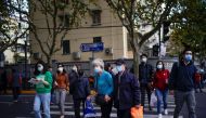 FILE PHOTO: People wearing face masks are seen on a street amid the global outbreak of the coronavirus disease (COVID-19) in Shanghai, China, November 18, 2020. REUTERS/Aly Song

