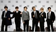Members of K-pop boy band BTS pose for photographs during a news conference promoting their new album 