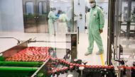A laboratory technician supervises capped vials during filling and packaging tests for the large-scale production and supply of the University of Oxford’s COVID-19 vaccine candidate, AZD1222, conducted on a high-performance aseptic vial filling line on Se