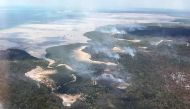 This handout picture taken on November 29, 2020, and released by the Queensland Fire and Emergency Services shows an aerial view of bushfires on Fraser Island, off Australia's east coast. AFP / Queensland Fire and Emergency Services 