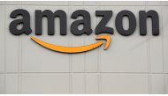 The Amazon logo is pictured outside the company's JFK8 distribution center in Staten Island, New York, U.S. November 25, 2020. REUTERS/Brendan McDermid/File Photo