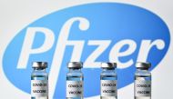 In this file photo taken on November 17, 2020 (FILES) This file photo illustration picture shows vials with Covid-19 Vaccine stickers attached, with the logo of US pharmaceutical company Pfizer, on November 17, 2020. Britain on December 2, 2020 became the