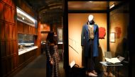 A museum employee poses for media next to Newt Scamander's costume, part of the 'Fantastic Beasts: The Wonder of Nature' exhibition opening soon at the Natural History Museum in London, Britain, December 8, 2020. Picture taken December 8, 2020. REUTERS/He