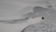 File photo: A worker adjusts a Vlies fabric to cover the snow of a glacier at Stubaier glacier ski resort near Neustift im Stubaital, Austria, May 7, 2020. Reuters/Lisi Niesner/File Photo