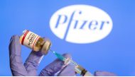 File photo: A woman holds a small bottle labeled with a 