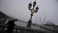 A man crosses Westminster Bridge with the London Eye wheel seen behind on a foggy morning, amid the spread of the coronavirus disease (COVID-19), London, Britain, December 7, 2020. Reuters /Toby Melville