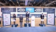 The podium winners of the Medium Level Dressage competition of the sixth round of the Longines Hathab Qatar Equestrian Tour, Jassim Al Jaham Al Kuwari, Maryam Ahmed Alsemaitt and Saoud Ahmed Al Boinin posing for a photograph with officials at the Qatar Eq