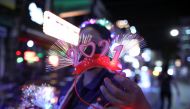 A woman sells a 2021 decoration at a popular entertainment street on New Year's Eve during the coronavirus disease (COVID-19) outbreak, in Bangkok, Thailand December 31, 2020. REUTERS/Soe Zeya Tun
