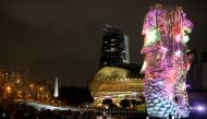 People watch a light show, as the traditional New Year's Eve fireworks are cancelled due to the coronavirus disease (COVID-19) outbreak, at Marina Bay in Singapore December 31, 2020. REUTERS/Edgar Su
