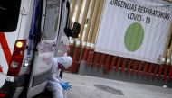 A paramedic waits outside the General Hospital for an available hospital bed for a patient showing symptoms of the coronavirus disease (COVID-19) to be admitted, in Mexico City, Mexico January 7, 2021. The sign reads 