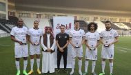Al Sadd stars Abdelkarim Hassan, Akram Afif, Khoukhi Boualem, Pedro Miguel, and Baghdad Bounedjah posing for a photograph with Xavi Hernandez and an official after they were honoured by the club for being selected in Qatar Players Association's Best XI fo
