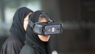A Northwestern Qatar student using VR glasses.