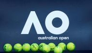 Tennis balls are pictured in front of the Australian Open logo before the tennis tournament. REUTERS/Thomas Peter//File Photo