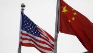 Chinese and US flags flutter outside the building of an American company in Beijing, China January 21, 2021. REUTERS/Tingshu Wang